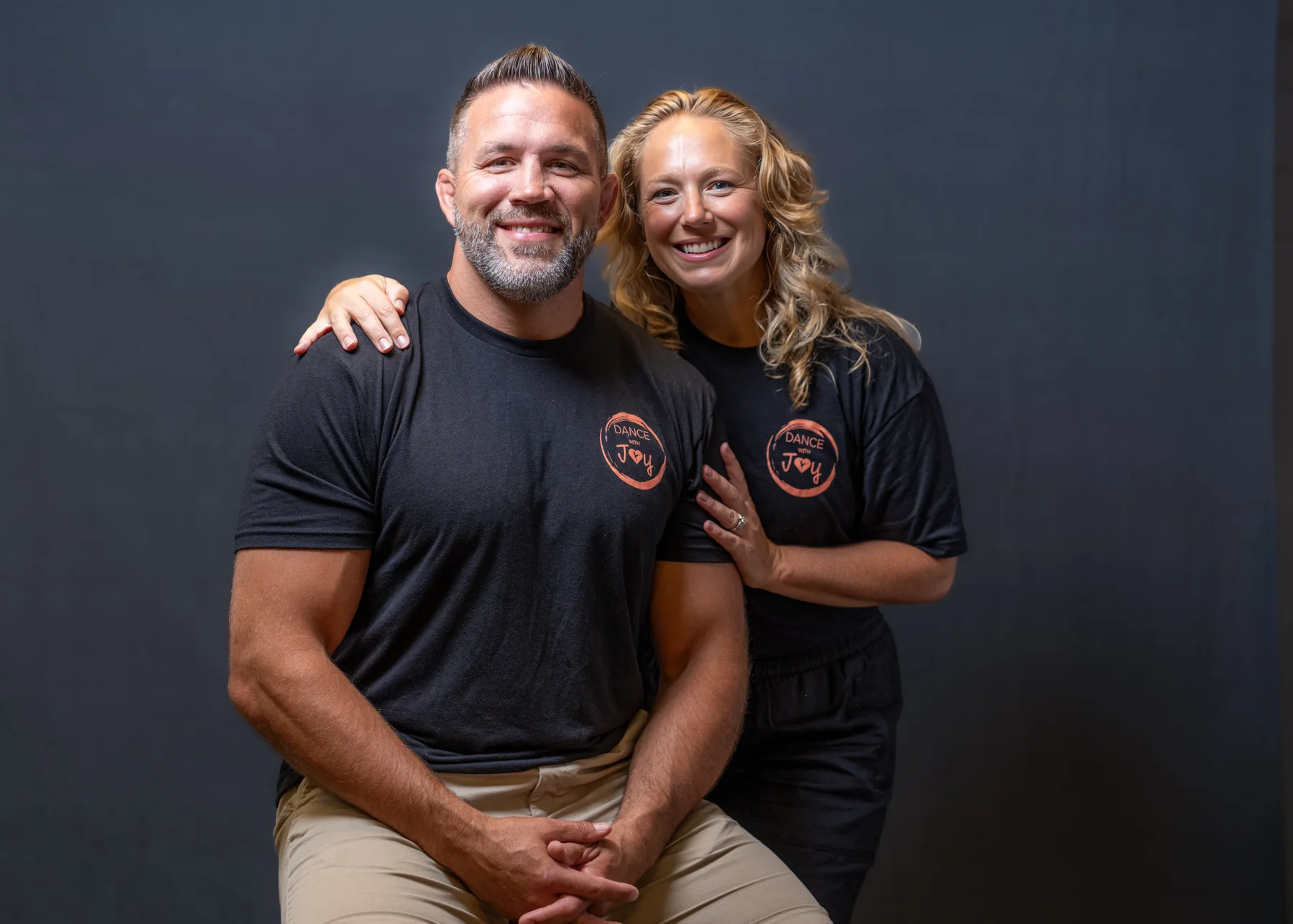 Two Dance with Joy team members smiling together in a studio portrait