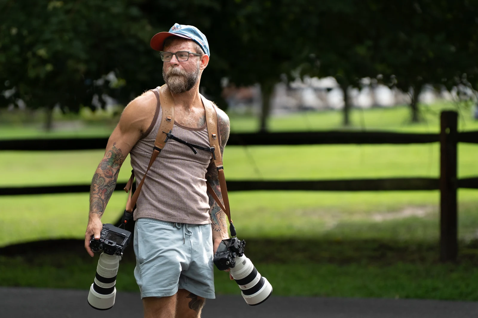 Francis outdoors with two cameras on a shoulder harness